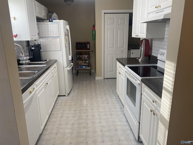 kitchen with white appliances, white cabinets, washer / dryer, decorative backsplash, and sink