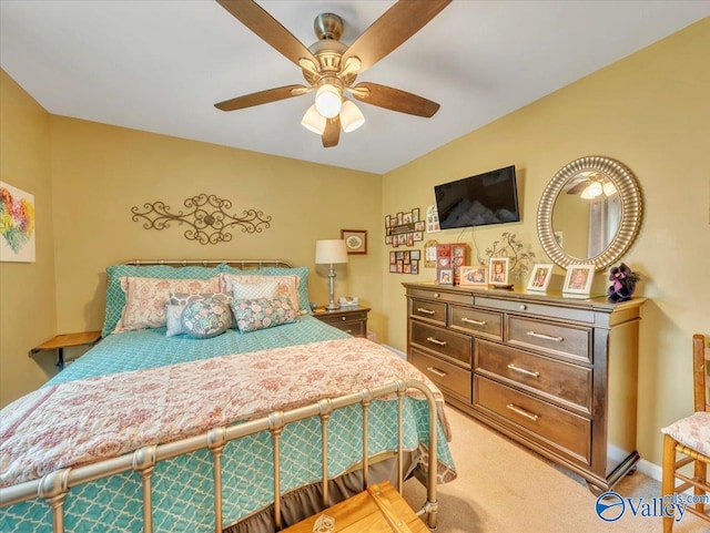 bedroom with light carpet, a ceiling fan, and baseboards