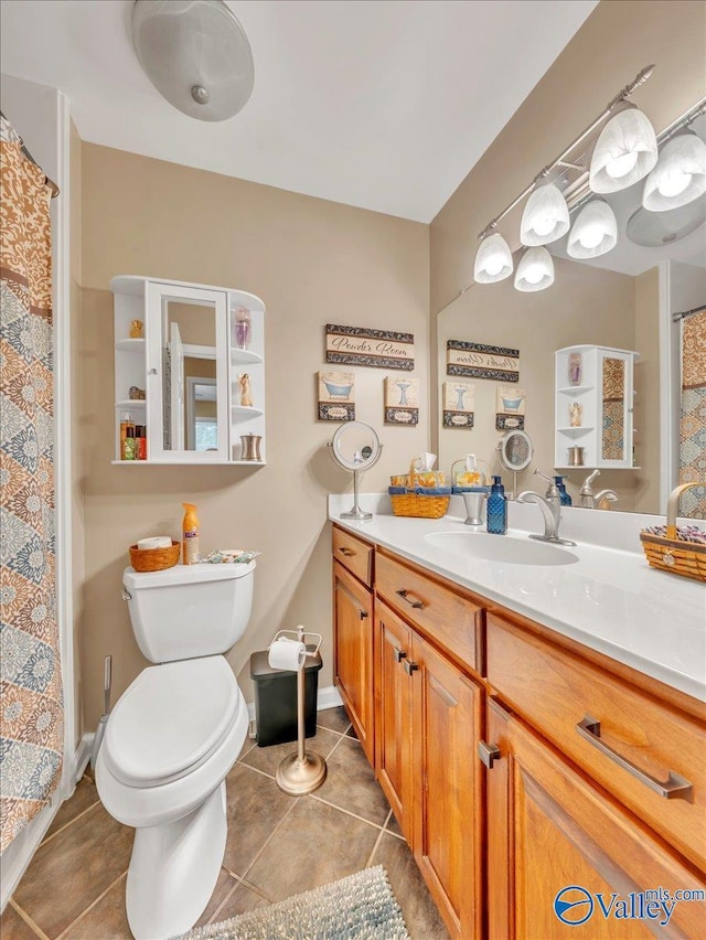 bathroom featuring tile patterned floors, toilet, vanity, and a shower with curtain