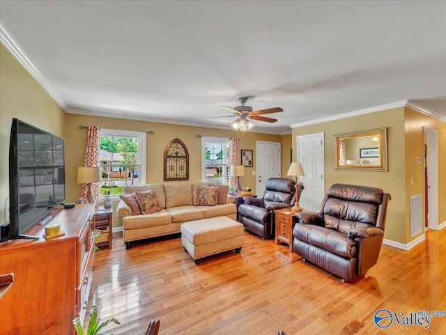 living room with a ceiling fan, crown molding, and light wood-type flooring