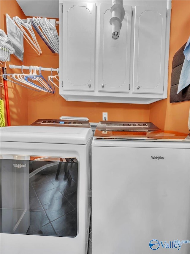 clothes washing area featuring independent washer and dryer and cabinet space
