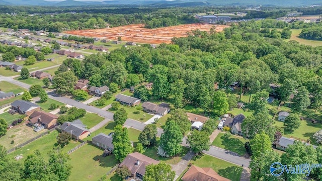 view of property location with a forest
