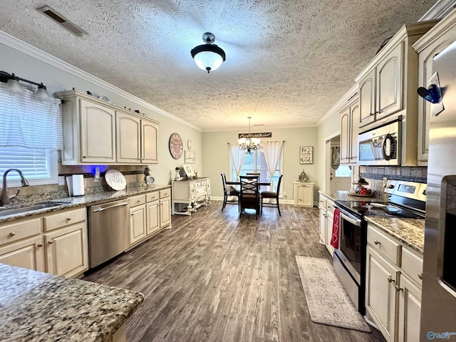 kitchen featuring pendant lighting, stainless steel appliances, dark hardwood / wood-style floors, and sink