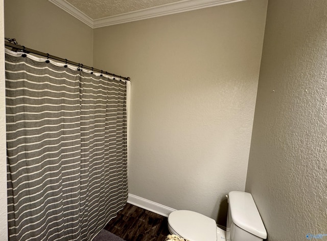 bathroom with crown molding, wood-type flooring, toilet, and a textured ceiling