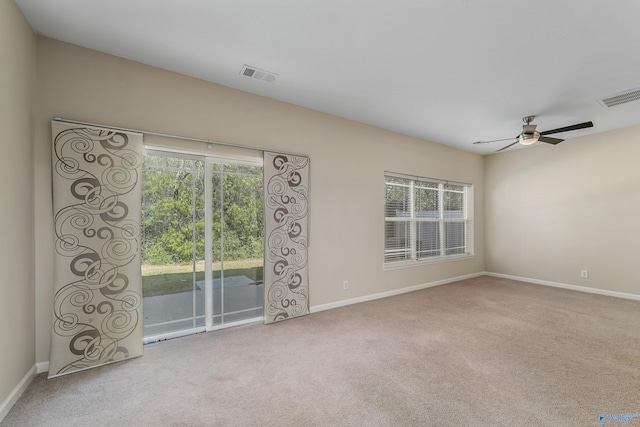 spare room featuring ceiling fan and carpet