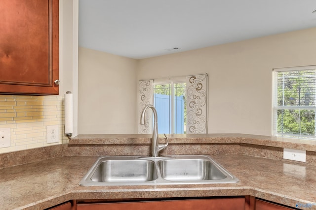 232 Falling Water Ln, Madison, AL 35756 - kitchen featuring a sink, tasteful backsplash, and brown cabinets