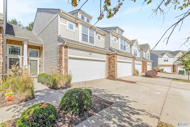 232 Falling Water Ln, Madison, AL 35756 - view of front facade with an attached garage, concrete driveway, a residential view, and stone siding