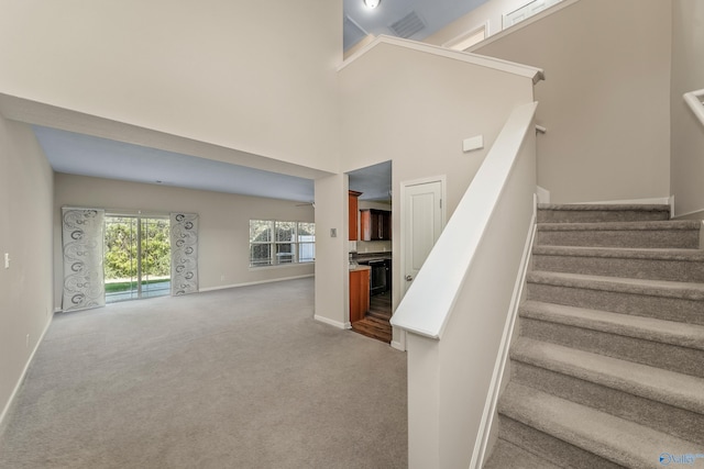 232 Falling Water Ln, Madison, AL 35756 - stairway with baseboards, carpet, and a high ceiling