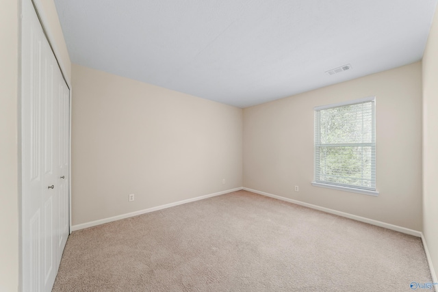 unfurnished bedroom with a closet and carpet flooring