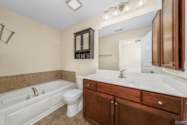 bathroom with vanity, tile patterned flooring, toilet, and a washtub