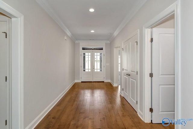 doorway to outside featuring french doors, wood-type flooring, and crown molding