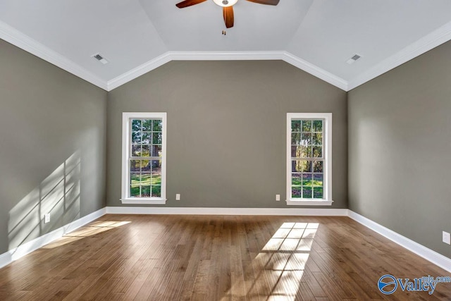 spare room featuring hardwood / wood-style flooring, a healthy amount of sunlight, and crown molding