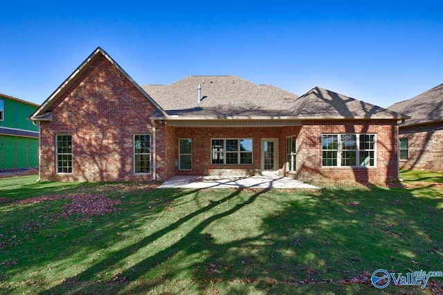 rear view of house featuring a patio and a yard