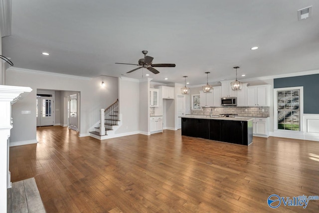 unfurnished living room with dark hardwood / wood-style floors and crown molding