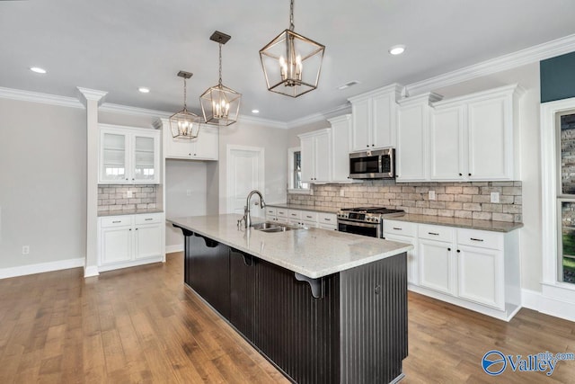 kitchen featuring white cabinetry, a center island with sink, appliances with stainless steel finishes, and sink