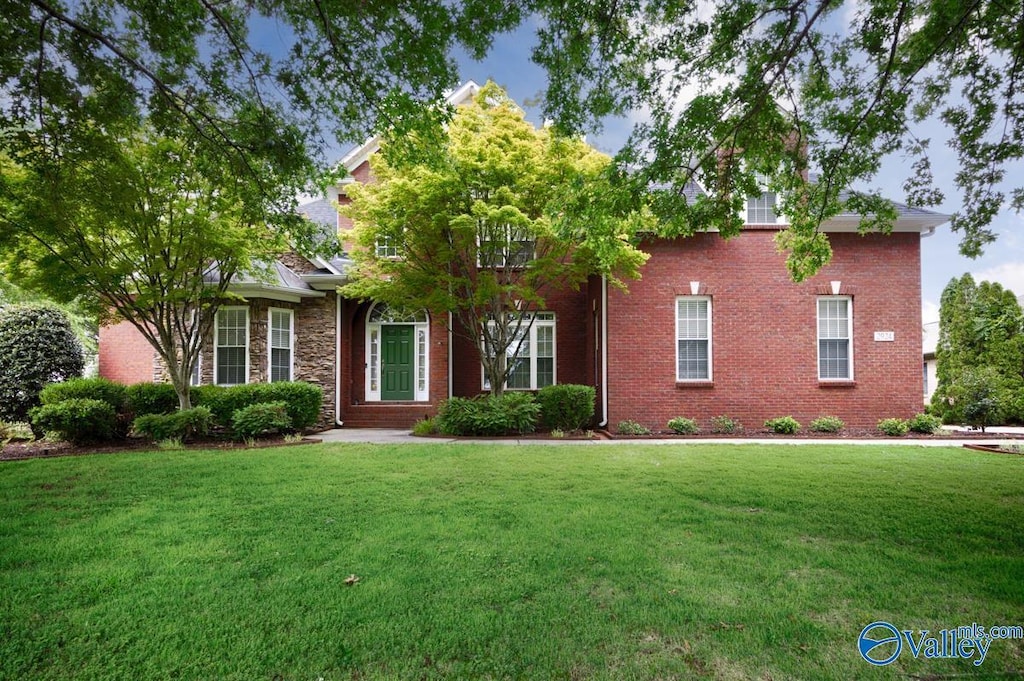 2924 Oakleigh Ln SE, Owens Cross Roads, AL 35763 - obstructed view of property featuring a front yard and stone siding
