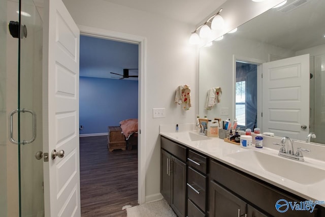 bathroom with ceiling fan, wood-type flooring, vanity, and an enclosed shower