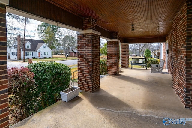 view of patio with covered porch and a residential view