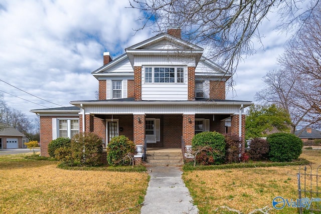 view of front of home with covered porch, brick siding, a chimney, and a front lawn