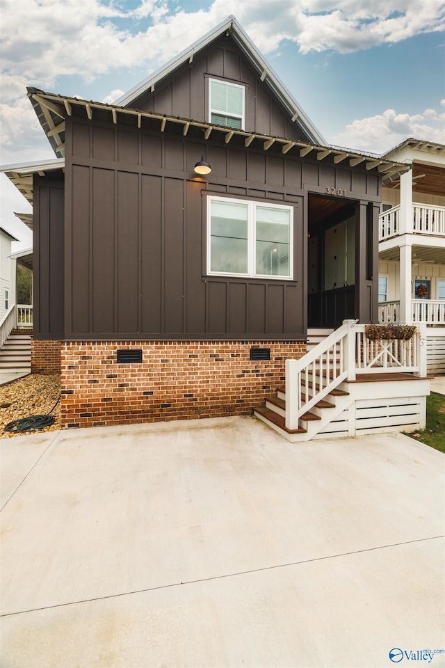 view of front of home featuring crawl space, a patio, and board and batten siding