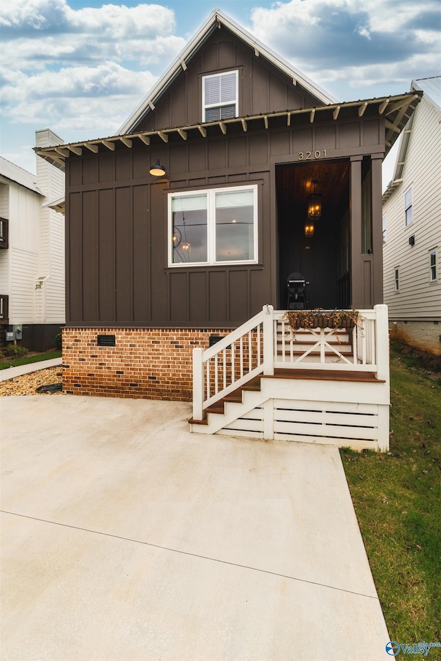 view of front of property featuring crawl space, board and batten siding, and a porch
