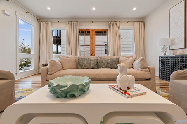 living area featuring recessed lighting, wood finished floors, and french doors
