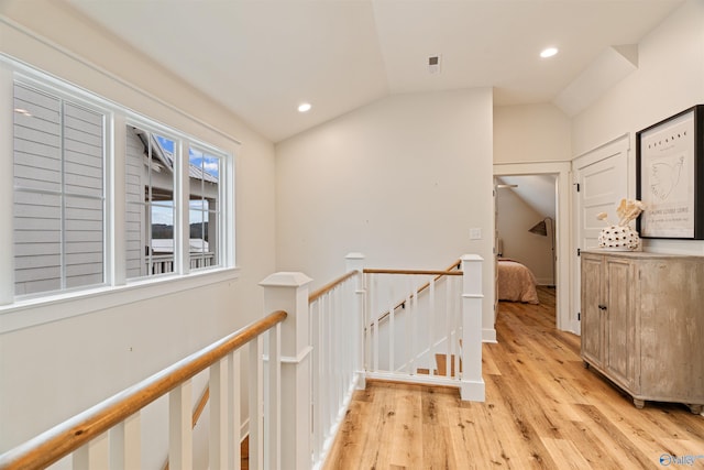 hall featuring lofted ceiling, recessed lighting, an upstairs landing, and light wood finished floors