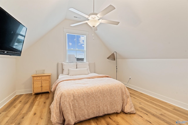 bedroom with visible vents, baseboards, vaulted ceiling, light wood-style flooring, and a ceiling fan