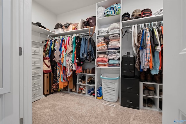 walk in closet featuring carpet