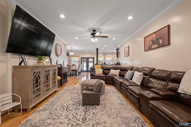 living room featuring light hardwood / wood-style floors, ceiling fan, and ornamental molding