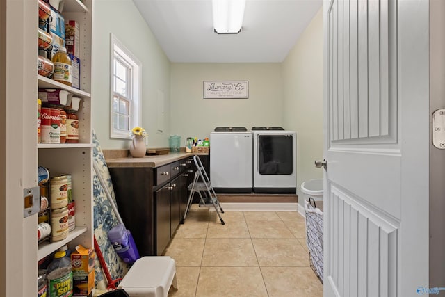 laundry area featuring washer and clothes dryer and light tile patterned floors