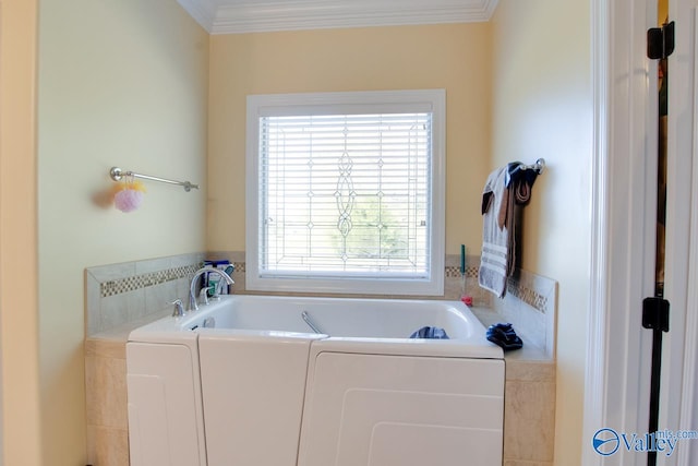 laundry room featuring ornamental molding and washing machine and clothes dryer