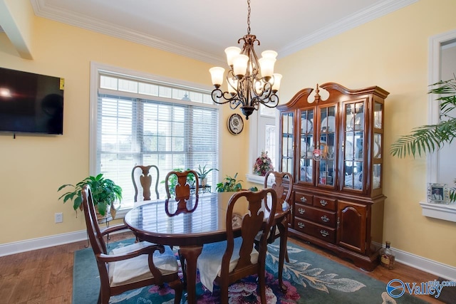 dining space with ornamental molding, a chandelier, and dark hardwood / wood-style floors