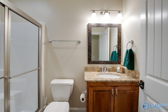 bathroom with vanity, toilet, and walk in shower