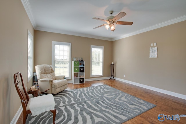 living area featuring crown molding, light hardwood / wood-style flooring, and ceiling fan