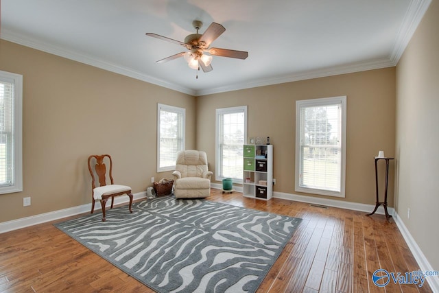 living area featuring ornamental molding, hardwood / wood-style floors, and ceiling fan