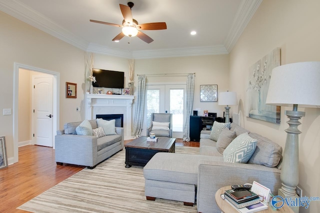 living room with ornamental molding, french doors, hardwood / wood-style flooring, and ceiling fan