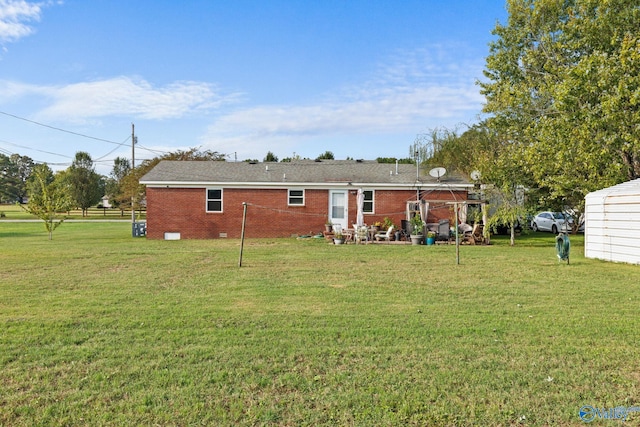 rear view of house featuring a lawn