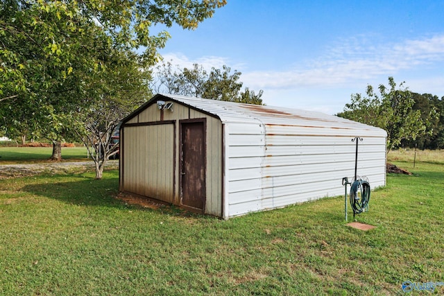 view of outbuilding featuring a lawn