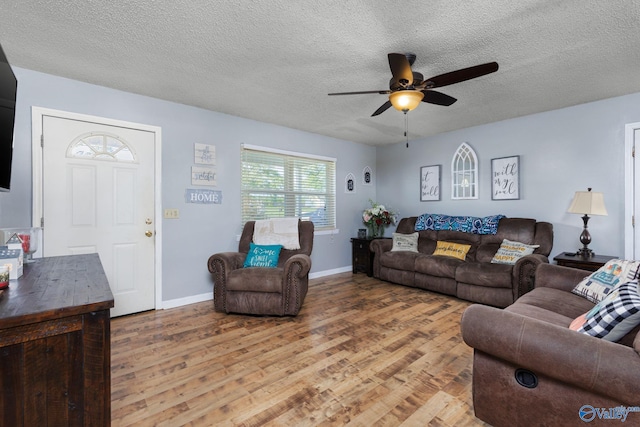 living room with wood-type flooring, a textured ceiling, and ceiling fan