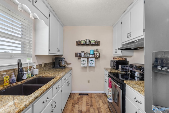 kitchen featuring light hardwood / wood-style floors, sink, stainless steel appliances, and white cabinets