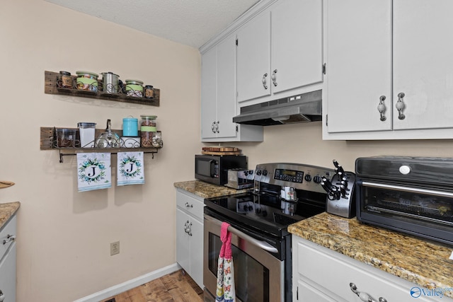 kitchen with white cabinets, a textured ceiling, light hardwood / wood-style flooring, dark stone countertops, and stainless steel electric range oven