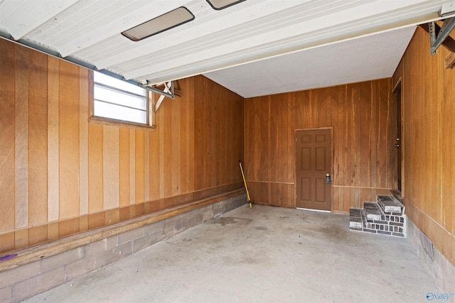 garage featuring wood walls