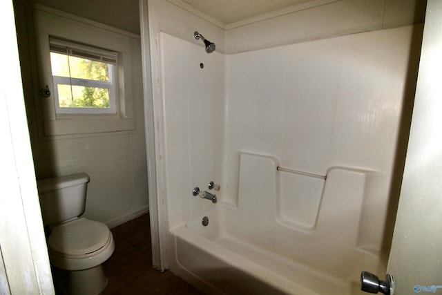 bathroom featuring tile patterned flooring, toilet, and shower / bath combination