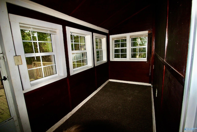 entryway with carpet flooring and vaulted ceiling