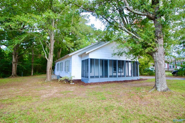 exterior space featuring a front yard and a sunroom