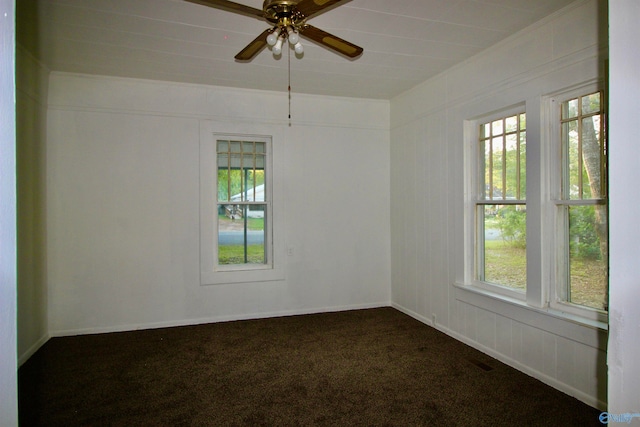 unfurnished room featuring ceiling fan and dark colored carpet