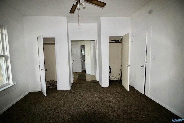 unfurnished bedroom featuring ceiling fan and dark carpet