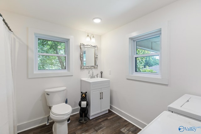 bathroom with toilet, hardwood / wood-style floors, a wealth of natural light, and vanity