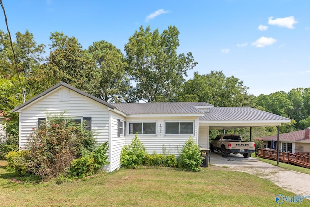 single story home featuring a carport, a wooden deck, and a front yard